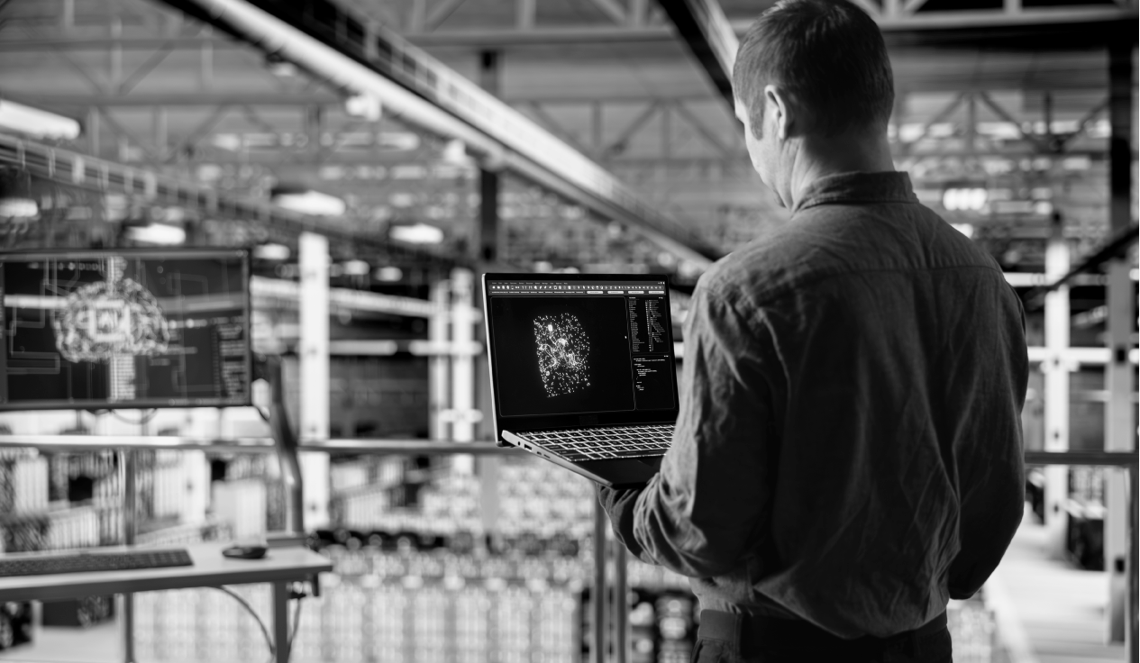 Especialista supervisando visualizaciones de seguridad en un entorno industrial, representando monitoreo de amenazas OT y ciberseguridad en infraestructuras críticas.